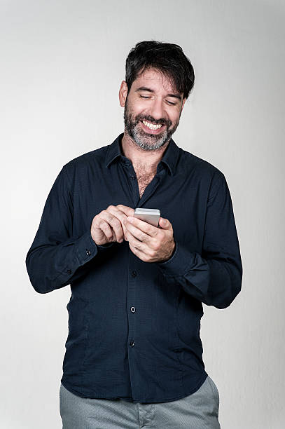 istock Man smiling at the phone 493109450