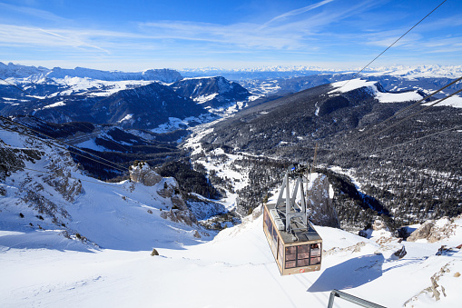 Campitello di fassa, Italy -  January 31, 2015: There is a cable car on ski resort in Alps. You can see a beautiful view from the top of the mountain.