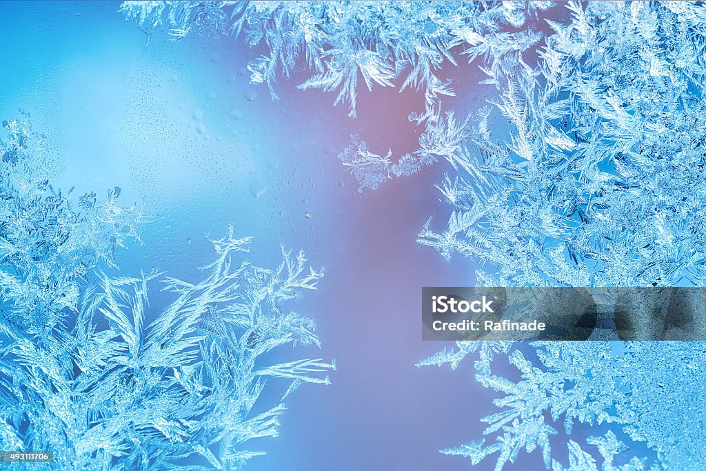 Frosted designs on glass Frozen windows in winter time with frost decorations Frost Stock Photo