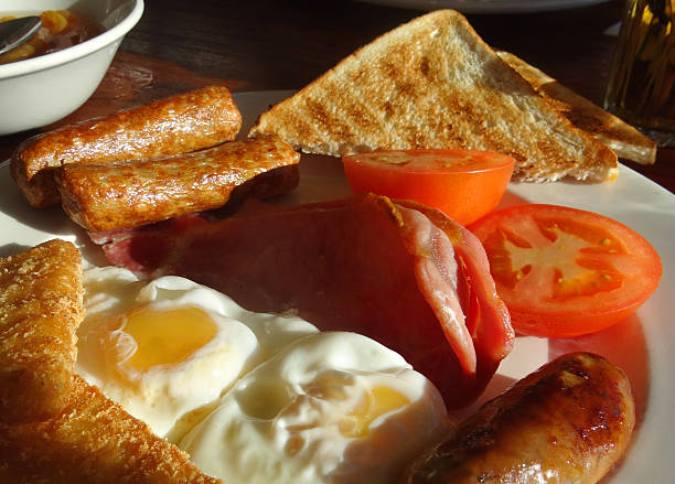 istock Image of greasy fried breakfast with sausages, eggs, bacon, tomatoes 493111720