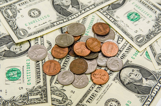 istock American Dollar bills with coins 493117026