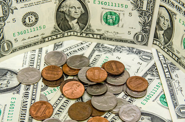 istock American Dollar bills with coins 493117156