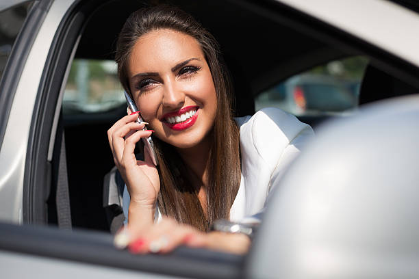 istock Woman using mobile cellphone in the car 493118964