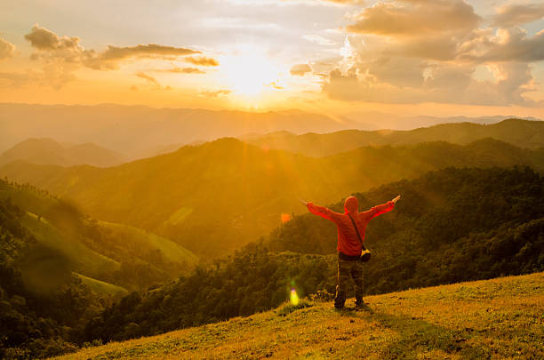 istock man welcome sunrise with raised hands 493119830