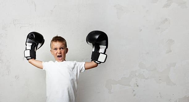 istock Little boy with boxing gloves celebrating his victory 493120860
