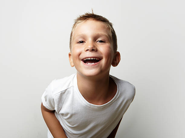 istock Little cute boy laughing at the camera. Blank wall on 493148526