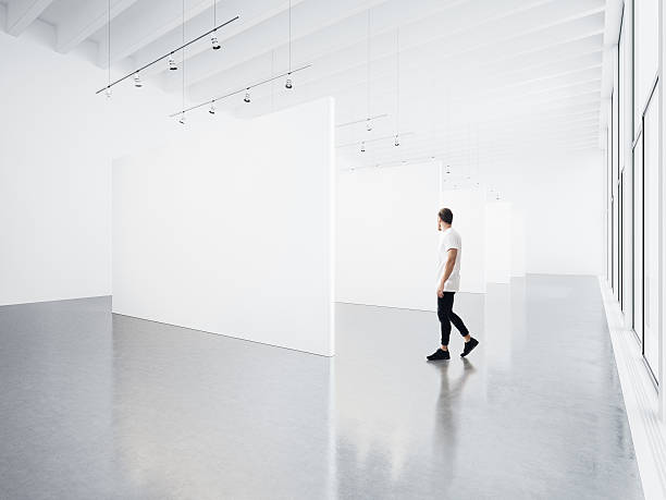 istock Gallery interior with white canvas and young man 493148674
