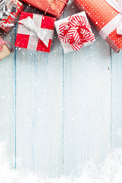 istock Christmas gift boxes on wooden table 493150726
