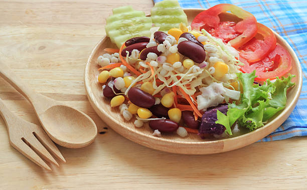 istock Healthy salad with fresh vegetables on wood background 493151428