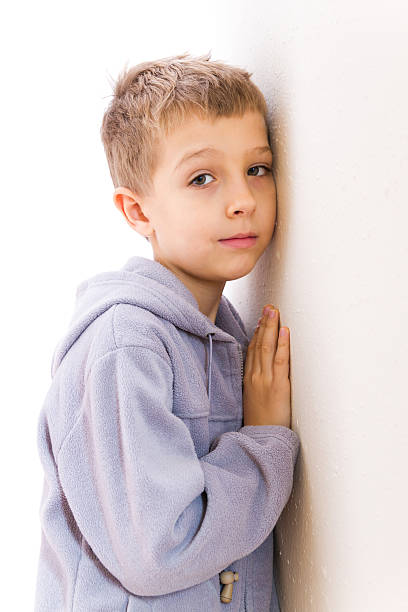 istock Boy is standing at the wall 493152542
