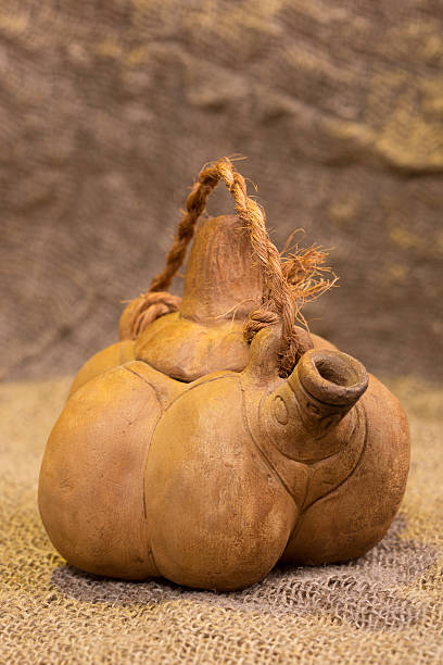 istock Kettle in the form a pumpkin on background of burlap 493152642