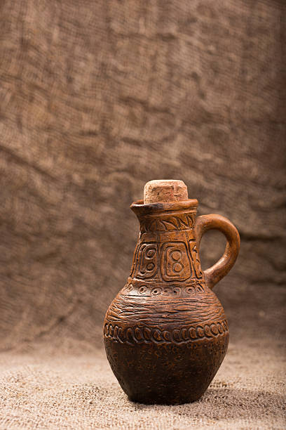 istock clay jug on background of burlap 493152734