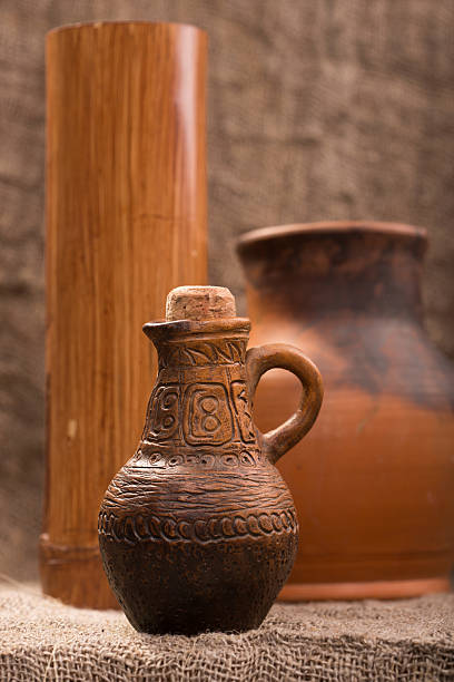 istock clay jug on background of burlap 493152928