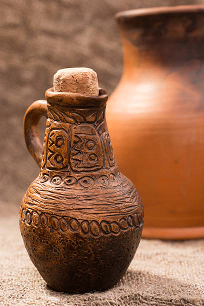 istock clay jug on background of burlap 493153008