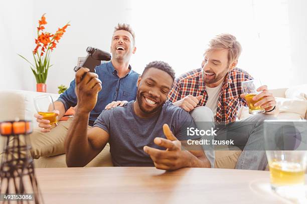 Three Guys Playing Video Games Stock Photo - Download Image Now - Control, Leisure Games, Video Game