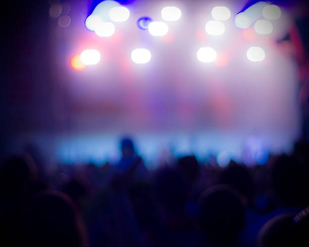istock Crowd at concert and blurred stage lights 493154744