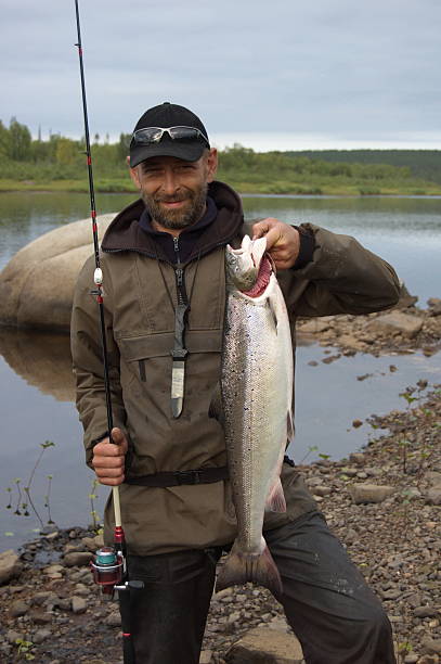 istock Fisherman caught large salmon in the north river. 493155498