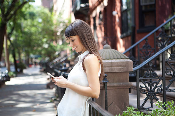 istock Woman using a smartphone outdoors 493155814