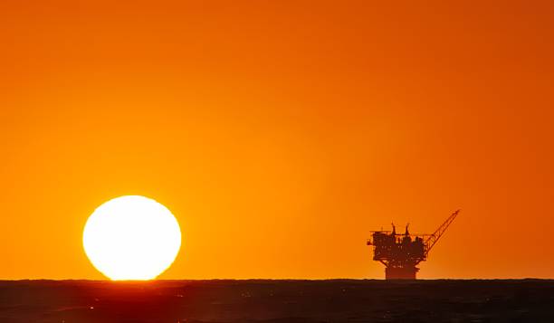 oil production platform and the sun stock photo