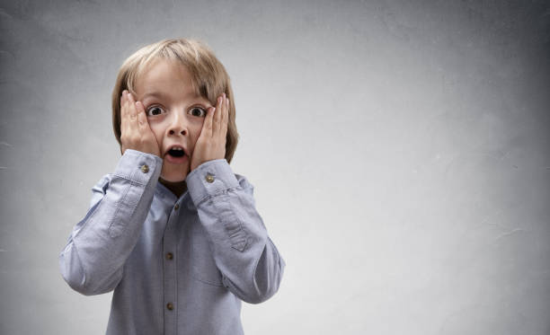 Shocked and surprised child Shocked and surprised boy with copy space concept for amazement, astonishment, making a mistake, stunned and speechless or back to school funny shock stock pictures, royalty-free photos & images