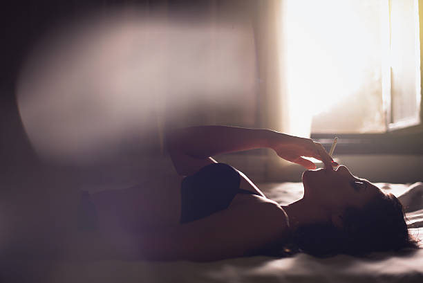istock Girl smoking in bedroom 493156660