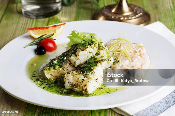 White Fish With Pesto Sauce And Meat Plate In A Stock Photo - Download Image Now - Pesto Sauce, Seafood, Food