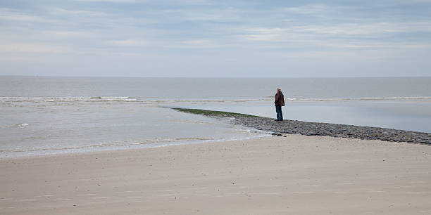 istock Germany, Wangerooge, North Sea, one man at beach 493157190