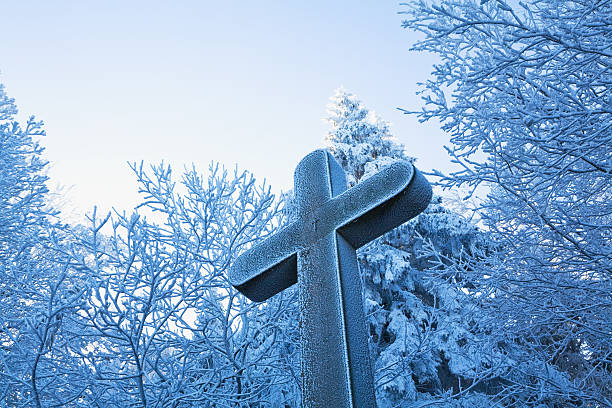 Forest, frost-covered weather cross in winter