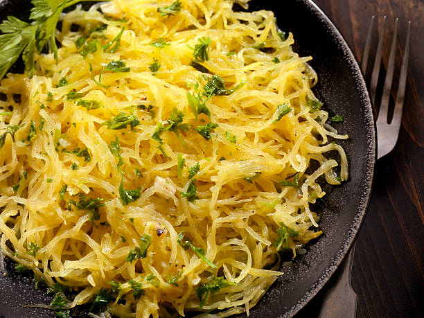 Spaghetti Squash with Garlic Herb Butter Spaghetti Squash with Garlic Herb Butter - Photographed on Hasselblad H3D2-39mb Camera Spaghetti Squash stock pictures, royalty-free photos & images