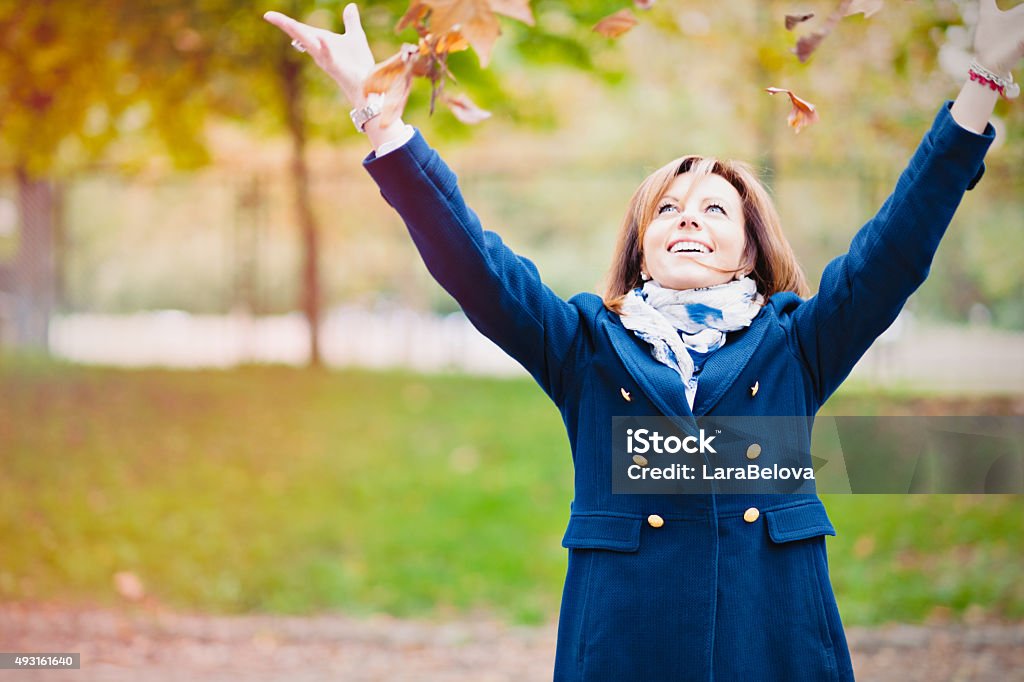 Mid age woman enjoying beautiful autumn weather in park 50-54 Years Stock Photo