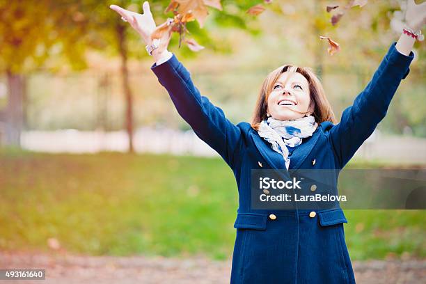 Mid Age Woman Enjoying Beautiful Autumn Weather In Park Stock Photo - Download Image Now