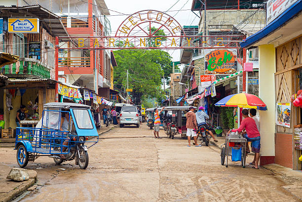 street view of Coron town Coron, Philippines - October 10, 2014: street view of Coron town in Palawan, Philippines. It is the largest town on Busuanga Island philippines tricycle stock pictures, royalty-free photos & images