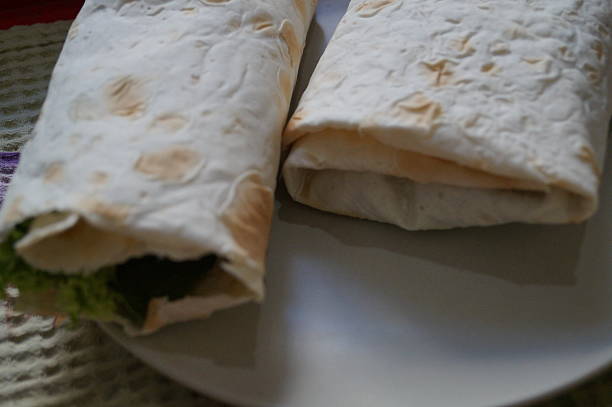 istock Pita bread with vegetables lying on the plate. 493163596