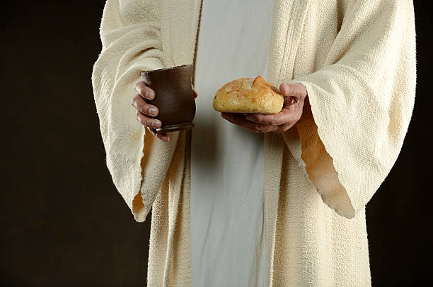 istock Jesus holding bread and a cup of wine 493163880