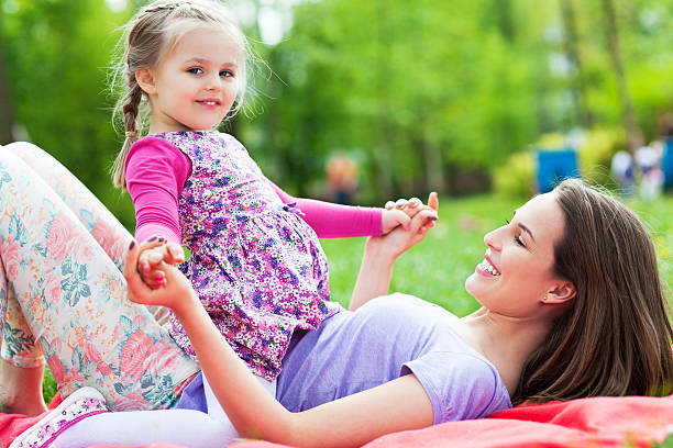 istock Mother and daughter on grass 493172509