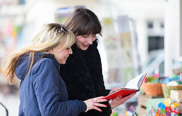 istock Young woman buying books 493173117