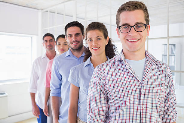 istock Happy business team standing in row at office 493174045