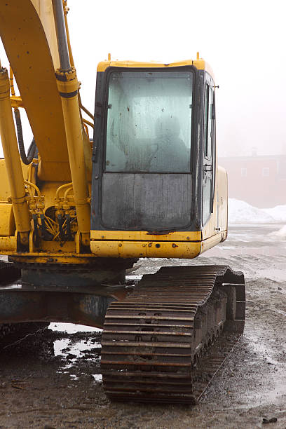istock Backhoe cabin on wet and foggy day 493177425