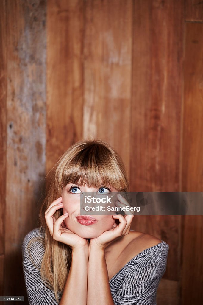 Woman deep in thought Young woman deep in thought, looking up 2015 Stock Photo