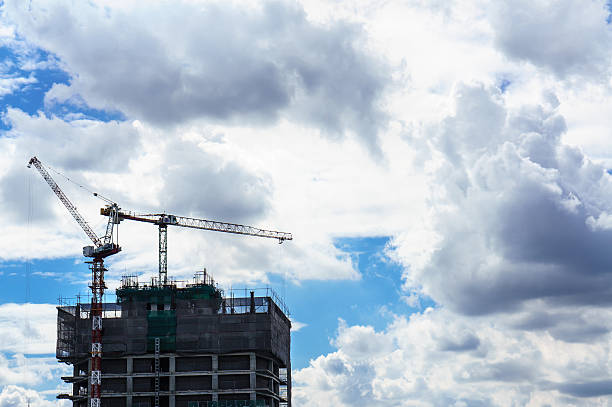 istock Crane and building construction site with blue sky 493182104