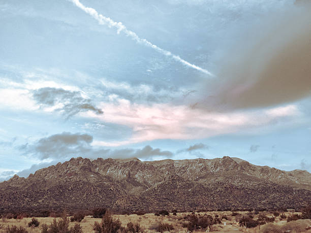 snow contrasts the desert terrain and mountain peaks.  horizontal mobilestock composition with retro color treatment taken in the sandia mountains of albuquerque, new mexico.