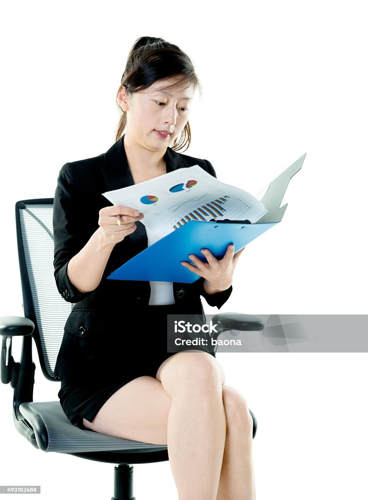 Businesswoman holding clipboard Businesswoman holding clipboard against white background. 2015 Stock Photo