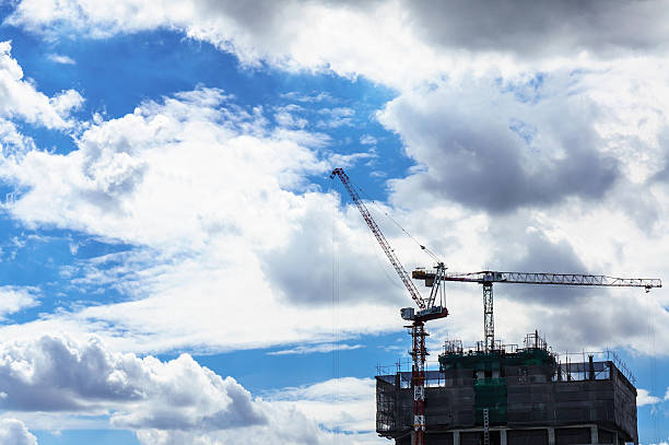 istock Crane and building construction site with blue sky 493184600