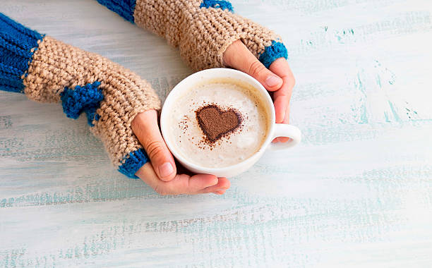 istock Holding Coffee Latte with Cozy Wool Hand Warmers 493186258