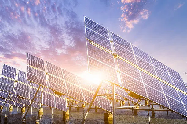 Photo of solar energy panels and wind turbines