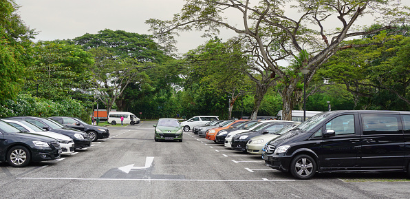 Singapore, Singapore - August 17, 2014: Car parking lot at bus terminal in Singapore. The per-capita car ownership rate in Singapore is 12 cars per 100 people (or 1 car per 8.25 people).