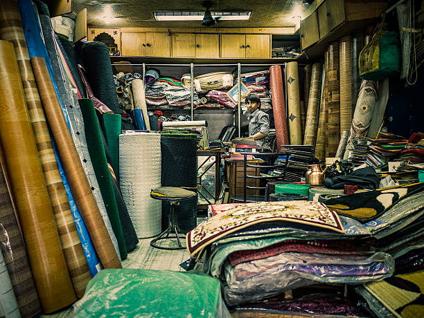 Jaipur, India - September 22, 2015: Shopkeeper in small floor store in an old bazaar in Jaipur Rajasthan India . Also known as the pink city it is the capital and also largest city in Rajasthan with close to seven million people