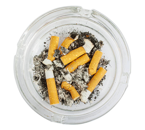 istock Stubs in glass ashtray top view 493190586