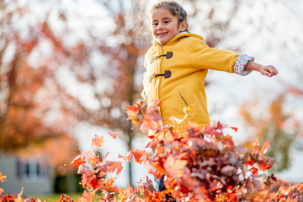 istock Cute Girl Having Fun Running Through the Leaves 493192650