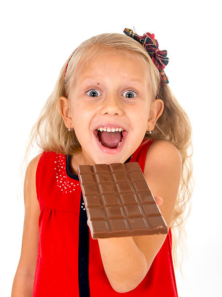 istock beautiful child eating delicious chocolate bar delighted 493193342